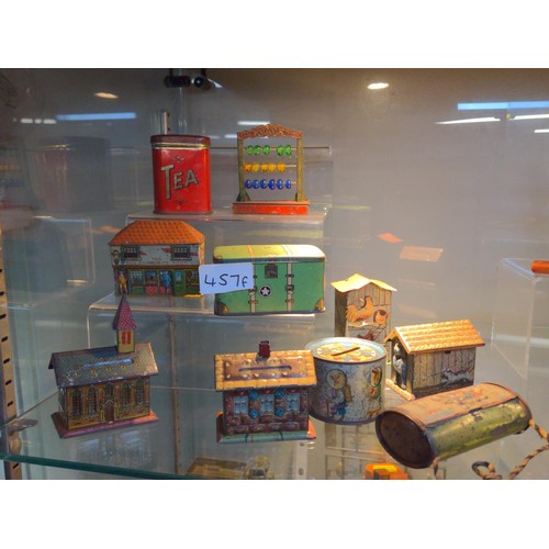 457F - Group of tin penny toy houses, shop and others.