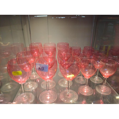 473 - Twelve cranberry glass wine glasses and eight other small stemmed glasses.