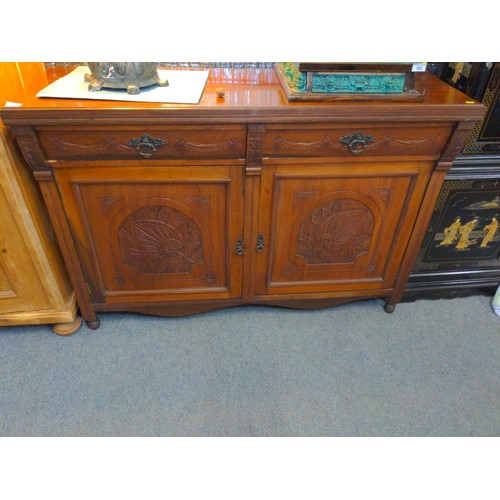 591 - Hard wood sideboard by George Eyre, Plymouth. With two drawers and lower cupboard and carved details... 