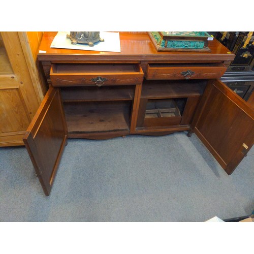 591 - Hard wood sideboard by George Eyre, Plymouth. With two drawers and lower cupboard and carved details... 