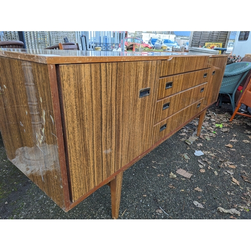 310 - Beautility mid century sideboard. 4 drawers flanked by cupboards. W183.5cm W45cm H78cm