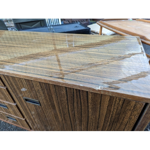 310 - Beautility mid century sideboard. 4 drawers flanked by cupboards. W183.5cm W45cm H78cm