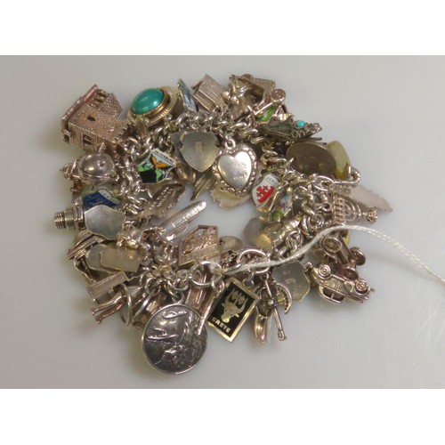 545 - Silver charm bracelet with 40+ charms, the charms mostly 925 silver, European grade silver or stampe... 