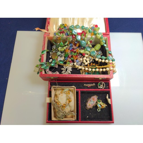 553 - Red jewellery box containing two silver brooches and various costume jewellery