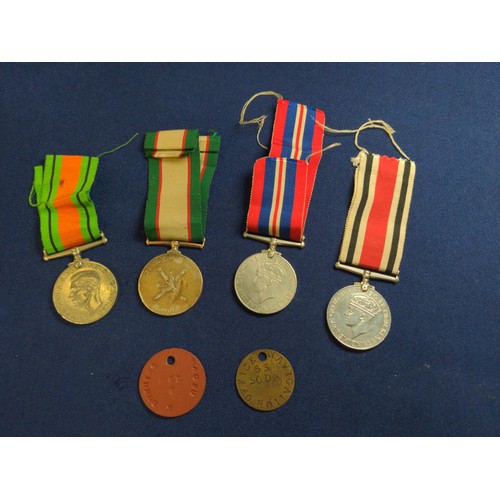 573 - Four medals including two WWII war medals, WWII defence medal and an Oman medal, together with two t... 