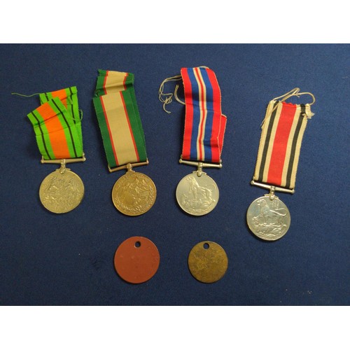 573 - Four medals including two WWII war medals, WWII defence medal and an Oman medal, together with two t... 