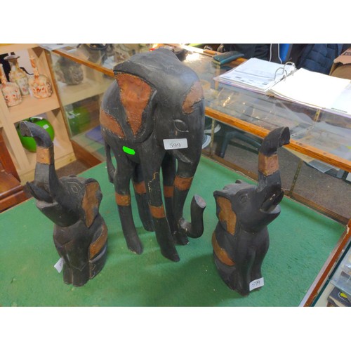 599 - Three decorative wooden elephants with applied metal, largest elephant 48cm