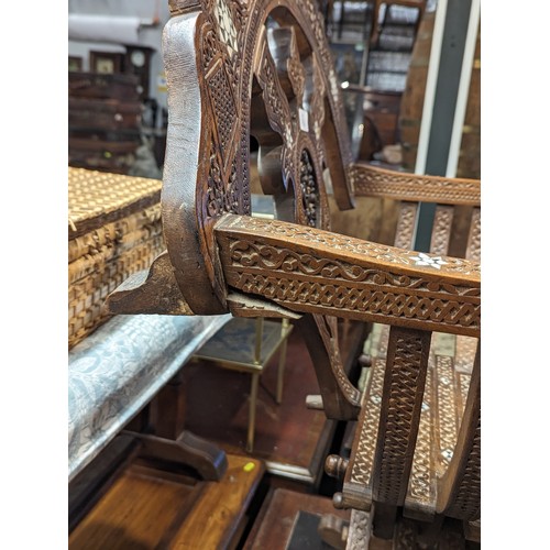 864 - Middle Eastern MOP inlaid heavily carved arm chair, Savonarola style.