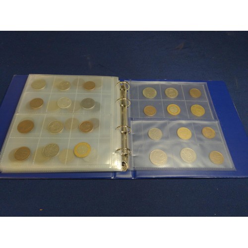 384 - Blue coin album containing mixed world coins, gross weight including album 1.53kg