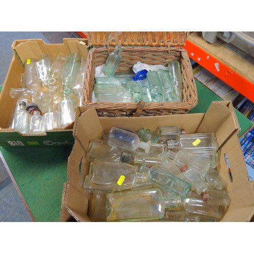 138 - Collection of vintage glass bottles in two boxes and a small wicker basket 