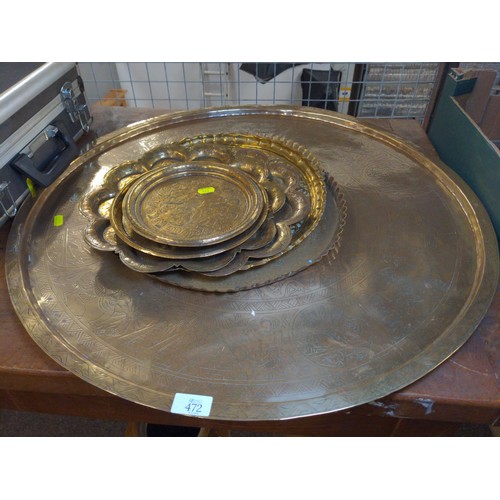 472 - Large Egyptian brass tray, dia. 74cm, together with seven smaller eastern brass trays