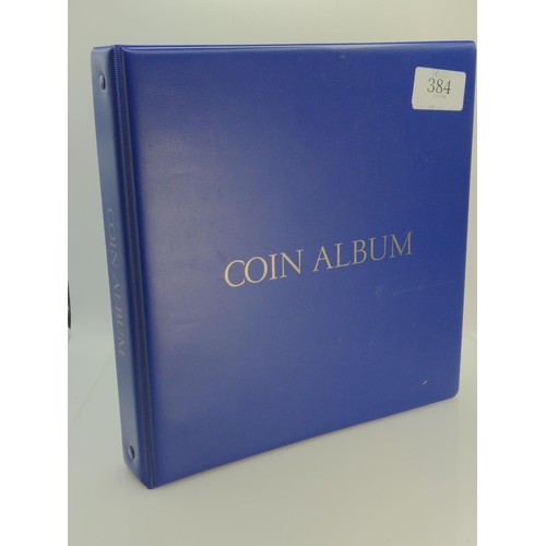 384 - Blue coin album containing mixed world coins, gross weight including album 1.53kg