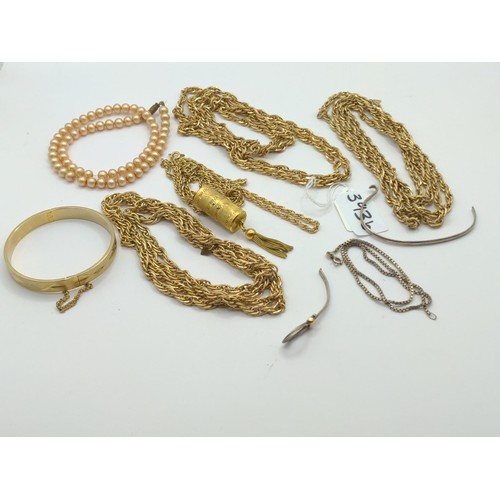 393B - Four long gold tone necklaces stamped Sarah COV. one has a tasselled watch pendant. Together with a ... 