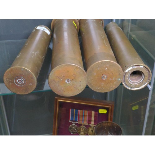 410 - Four military brass shells, including a pair of 'trench art' vases, height of pair 28.8cm