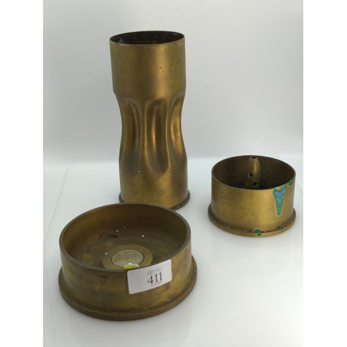 411 - Three pieces of brass trench art, including a vase and two ashtrays, one ashtray dated 1977 to base ... 