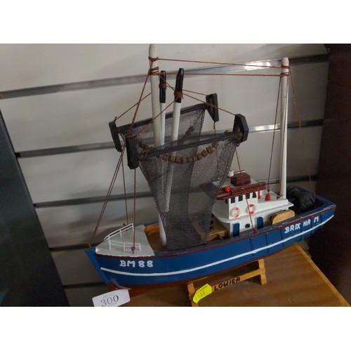 300 - Wooden model fishing boat. 29cm long.