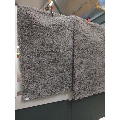 584 - Two shaggy grey rugs. 80cm x 150cm each