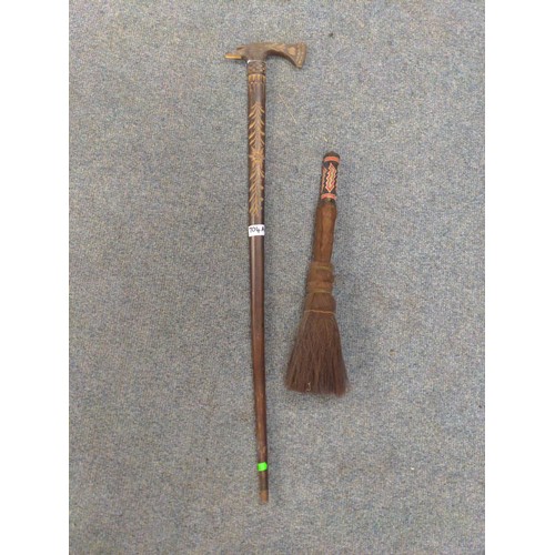 704A - Carved decorative axe 91cm long. Together with a horse tail brush with woven end.