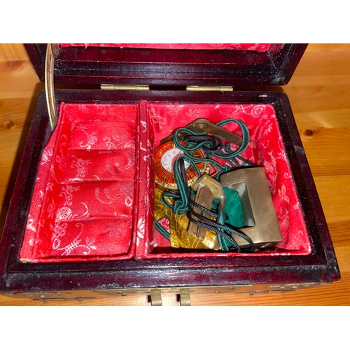 712 - Small box with brass detail and inlaid with jade. Including contents. 