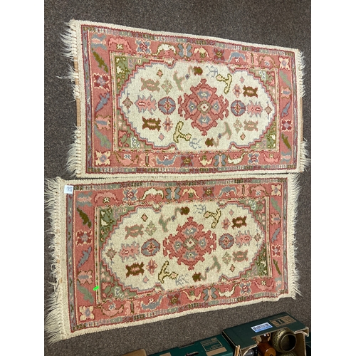 526 - Two hand finished wool rugs predominantly in pink shades with cream background. W69 L126cm