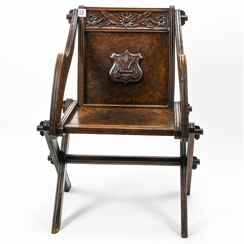 384 - C19 ak carved oak and walnut Glastonbury chair with  cross legs and centre turned stretcher. W65 D44... 