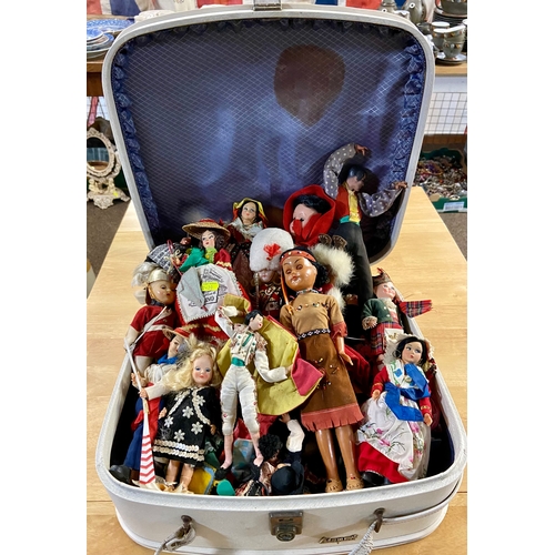 556 - Travel case full of miniature world dolls.