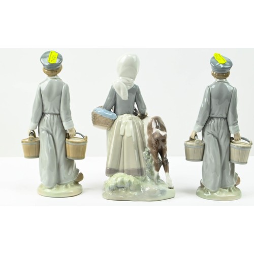 307 - Three Lladro figures including two Dutch boys with pails (one with repair to neck) and a girl with g... 