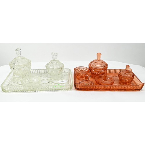 325 - Two glass dressing table sets, one peach coloured