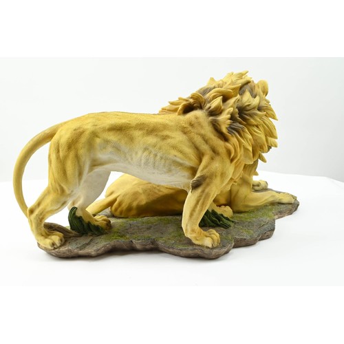 356 - Large resin sculpture of two lions. 52cm long x 26cm high.