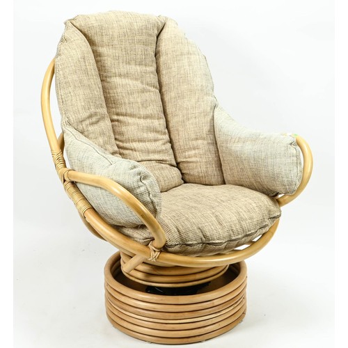 379 - Bamboo swivel rocking chair with oatmeal coloured cushions.