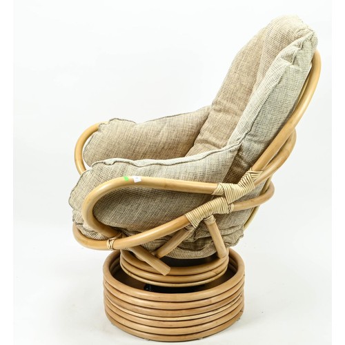 379 - Bamboo swivel rocking chair with oatmeal coloured cushions.