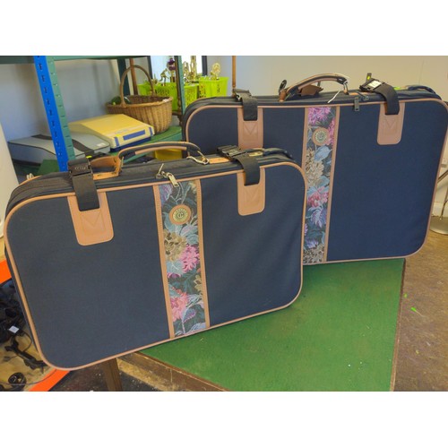 156 - Two Canvas Carlton international suitcases with wheels to one end