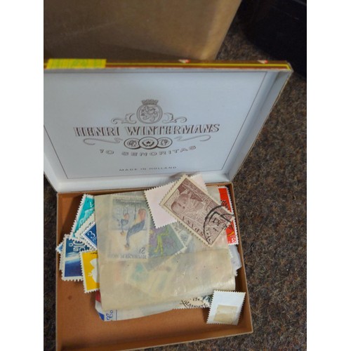 557 - Two boxes of mixed stamps, loose and albums of world stamps. 