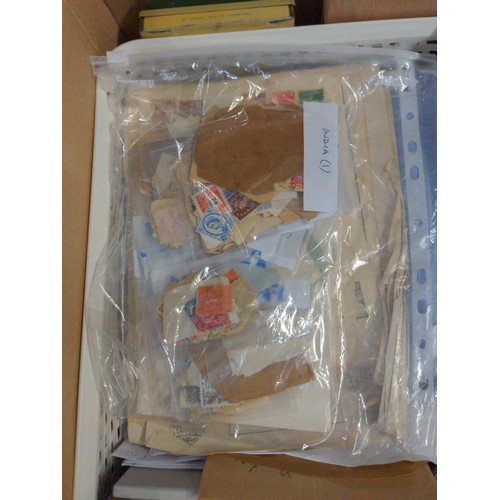 557 - Two boxes of mixed stamps, loose and albums of world stamps. 