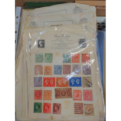 557 - Two boxes of mixed stamps, loose and albums of world stamps. 