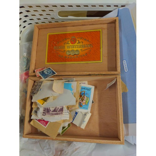 557 - Two boxes of mixed stamps, loose and albums of world stamps. 