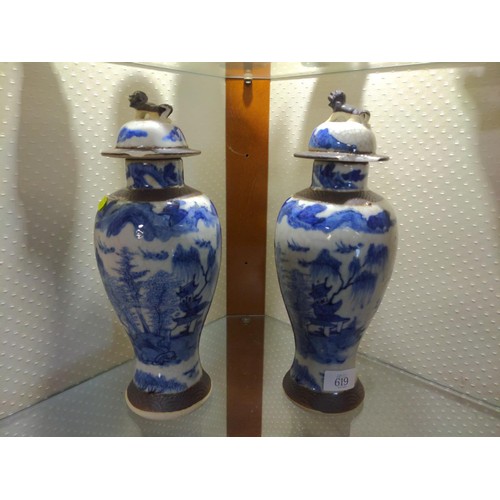 619 - Two blue and white lidded jars with Chinese mark to base and finial decoration. 