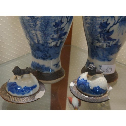 619 - Two blue and white lidded jars with Chinese mark to base and finial decoration. 