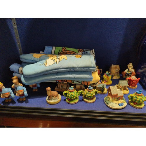 321 - Shelf of Tetley collectables inc. tins, miniature houses, tea towels etc.