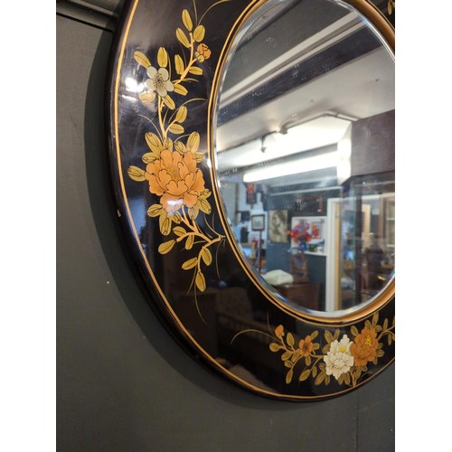 329 - Circular bevelled mirror with lacquered frame. Overall diameter 76cm. 