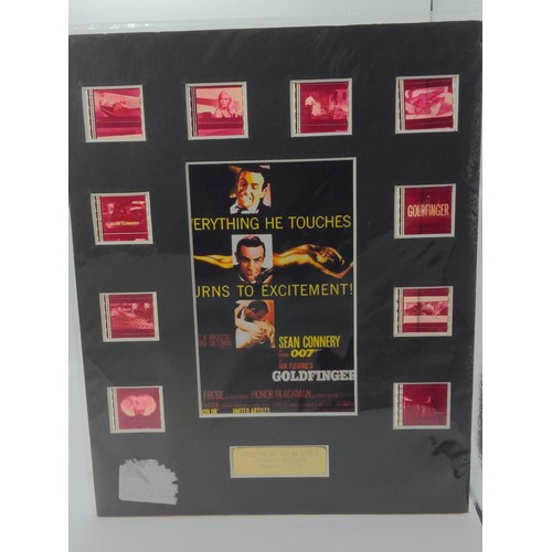 721 - James Bond, two mounted film cell presentation boards. Goldfinger & Tomorrow Never Dies.