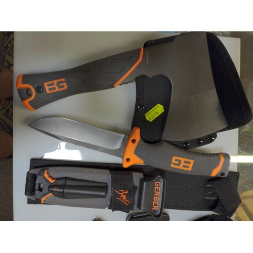 748 - Gerber-  Bear Grills hatchet together with survival knife and other pen knives etc.