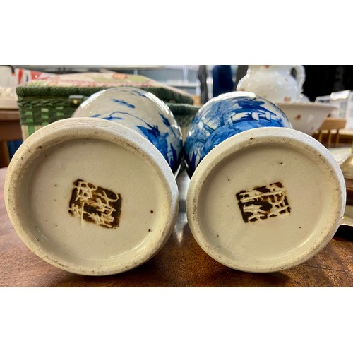 619 - Two blue and white lidded jars with Chinese mark to base and finial decoration. 