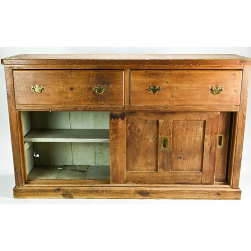 8 - Pitch pine Victorian sideboard. Featuring two drawers over sliding cupboard with brass handles.  W15... 