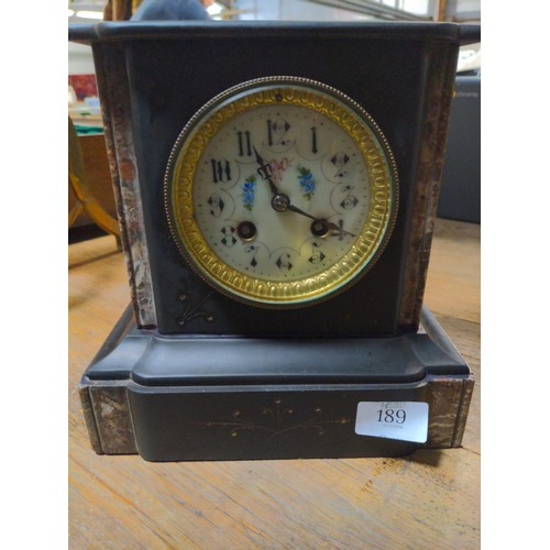 189 - Victoriana slate encased mantle clock with ornate trim and enamled face. H22.5 cm