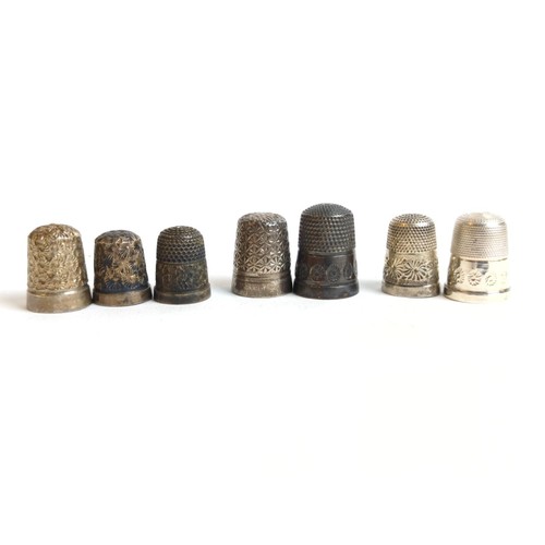 431 - Six silver thimbles, various makers and dates, gross weight 31.7 grams, & one silver plated thim... 