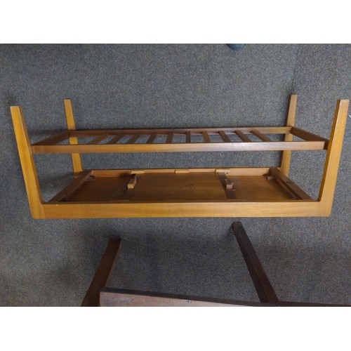 342 - Remploy teak coffee table with sliding top and rack to base. W111 D44.5 H42cm