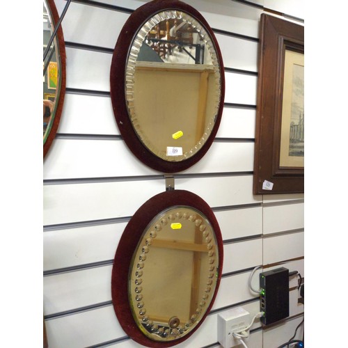 119 - Velvet oval backed Venetian style mirrors. 42cm x 32cm