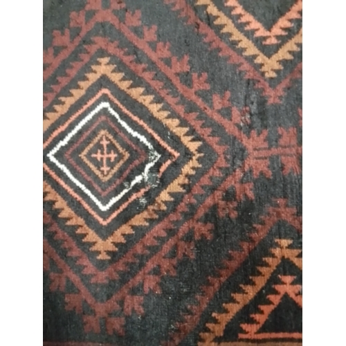 130 - Hand finished fringed Persian rug with Aztec style design . 234 x 118 cm