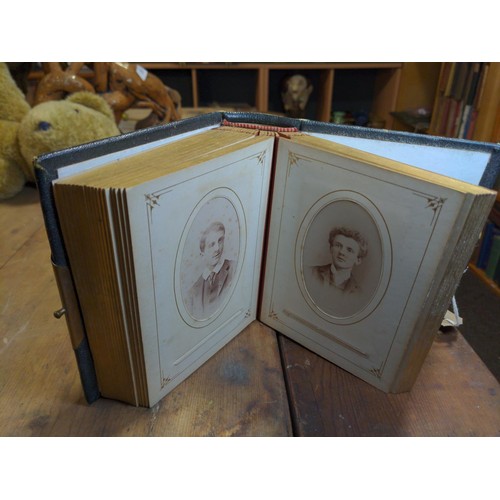 217 - Victorian gilt edged photo album with clasp and many portrait photographs